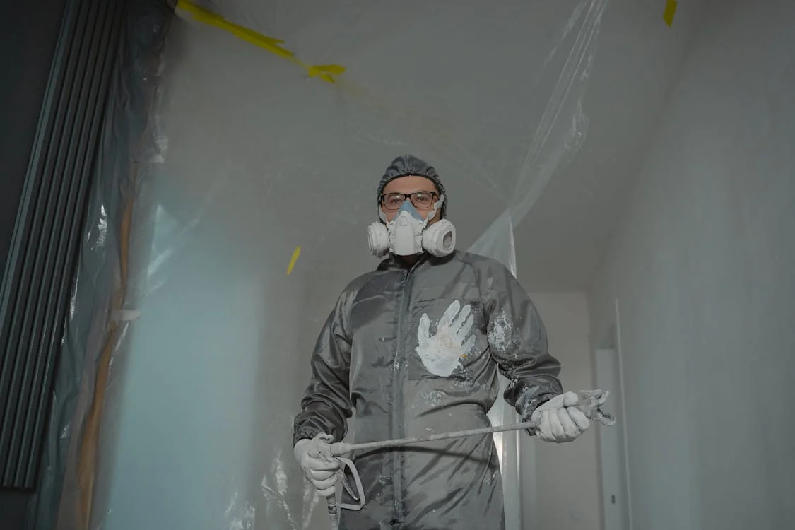 mold remediation dayton ohio — technician in protective gear treating basement mold